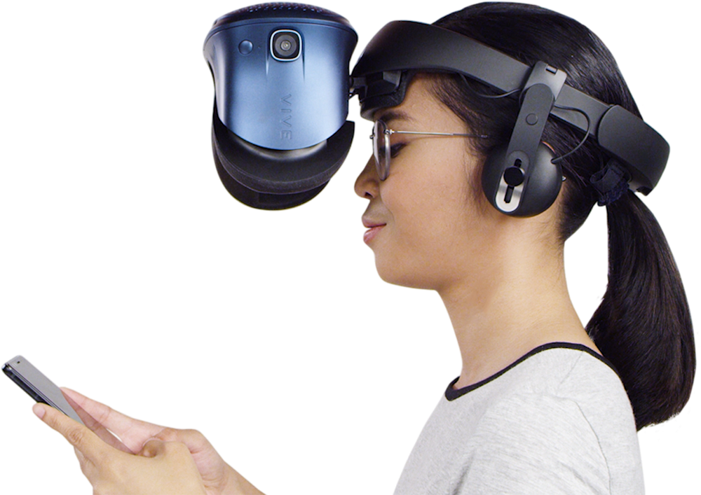 A woman wearing the Cosmos headset flipped up to allow her to view her phone